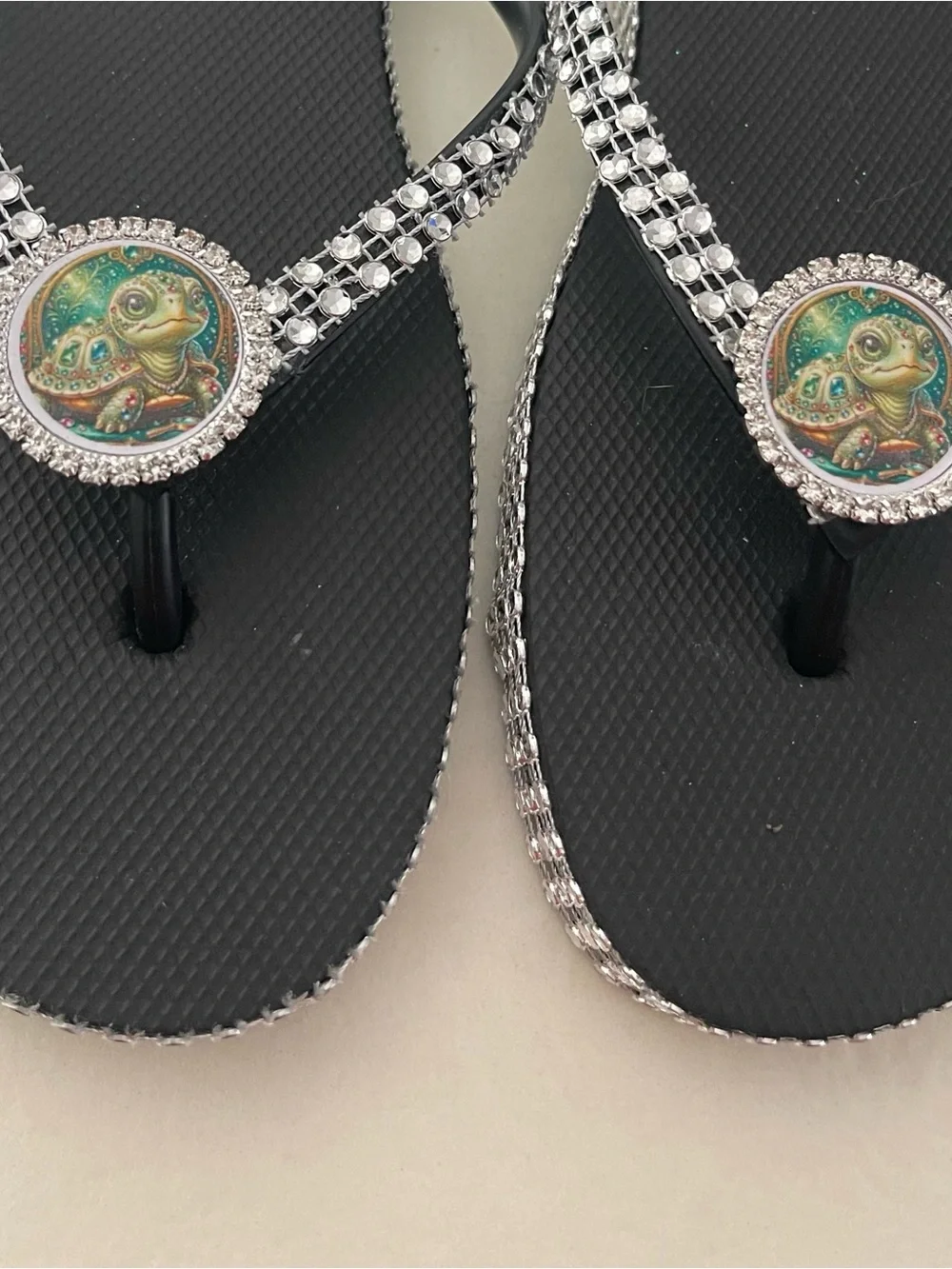 Black Crystal-Trim Flip Flop Sandals with Turtle Medallion